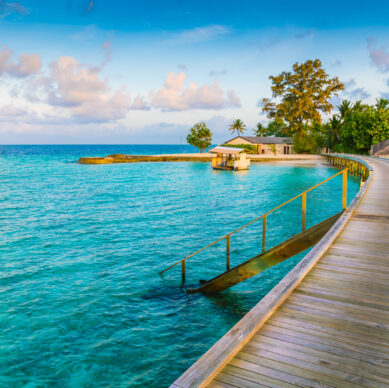 Beautiful water villas in tropical Maldives island at the sunrise time